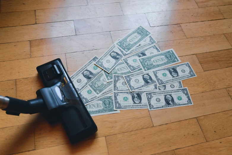 a number of bills lying on the ground with a lighter