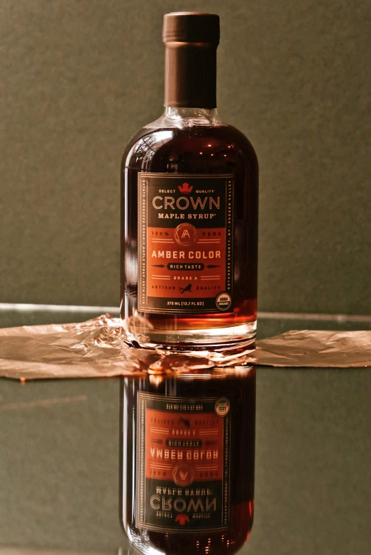 a brown bottle sitting next to a glass table