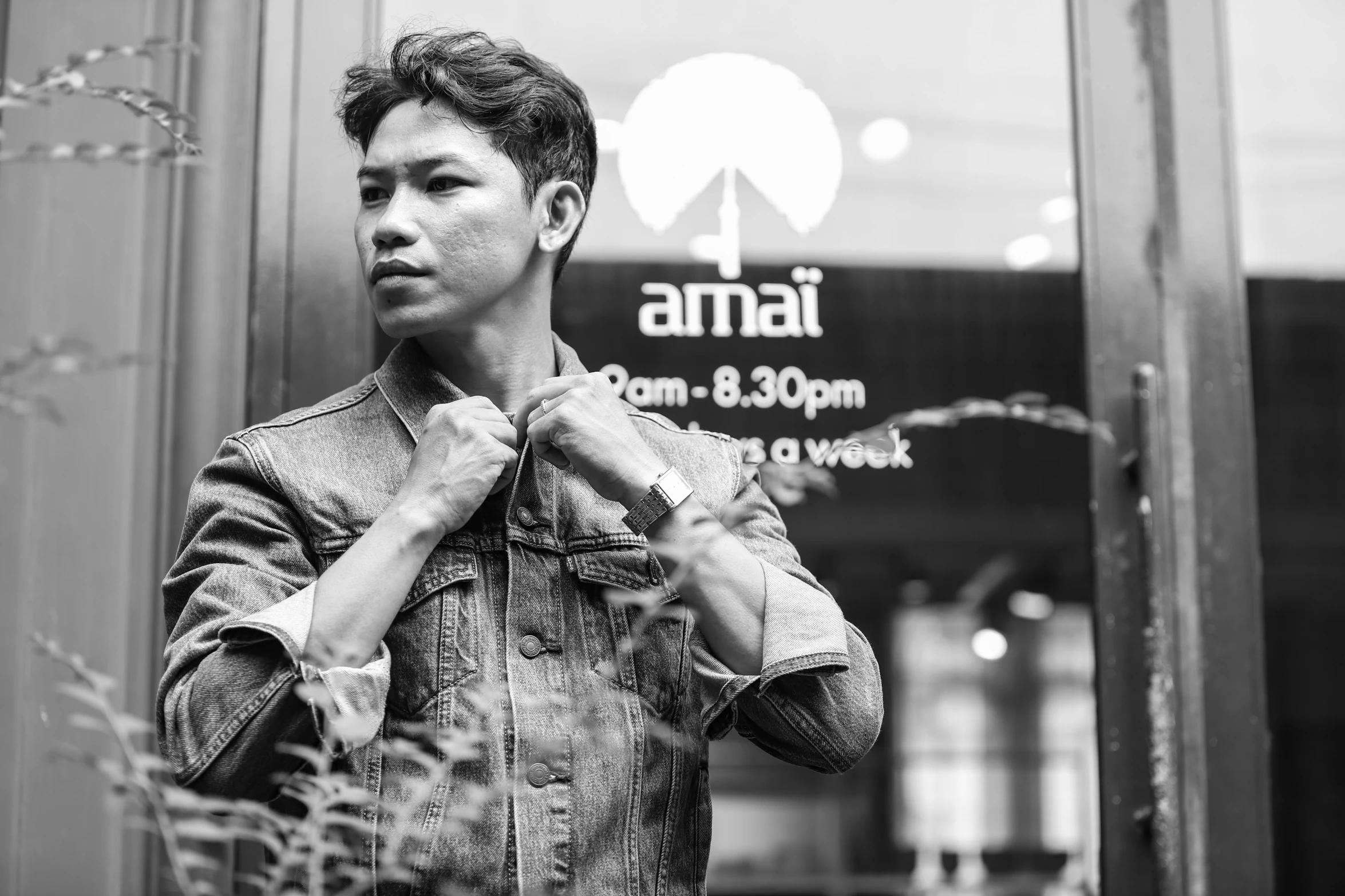 a man in a jacket standing next to the sign