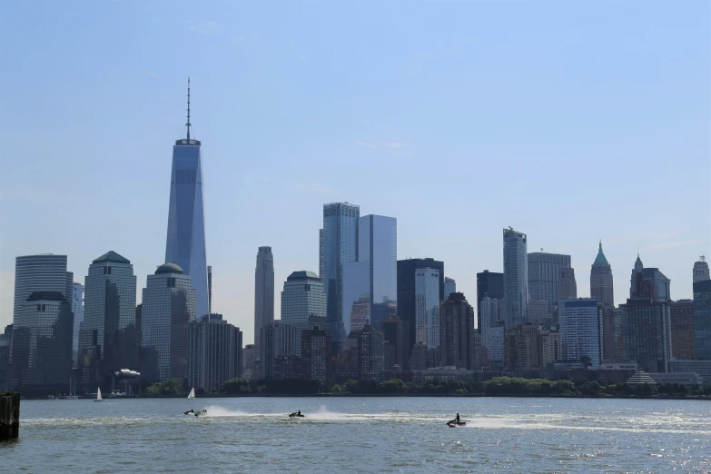 the skyline of the city is reflected in water