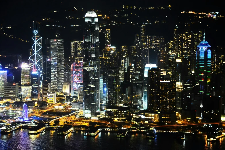 a large city at night with many boats in the bay