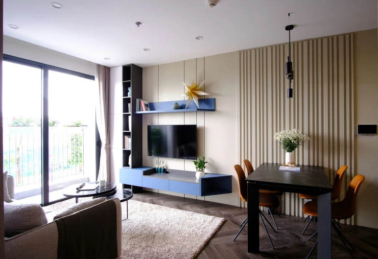 a view of a room with furniture, a table and a tv