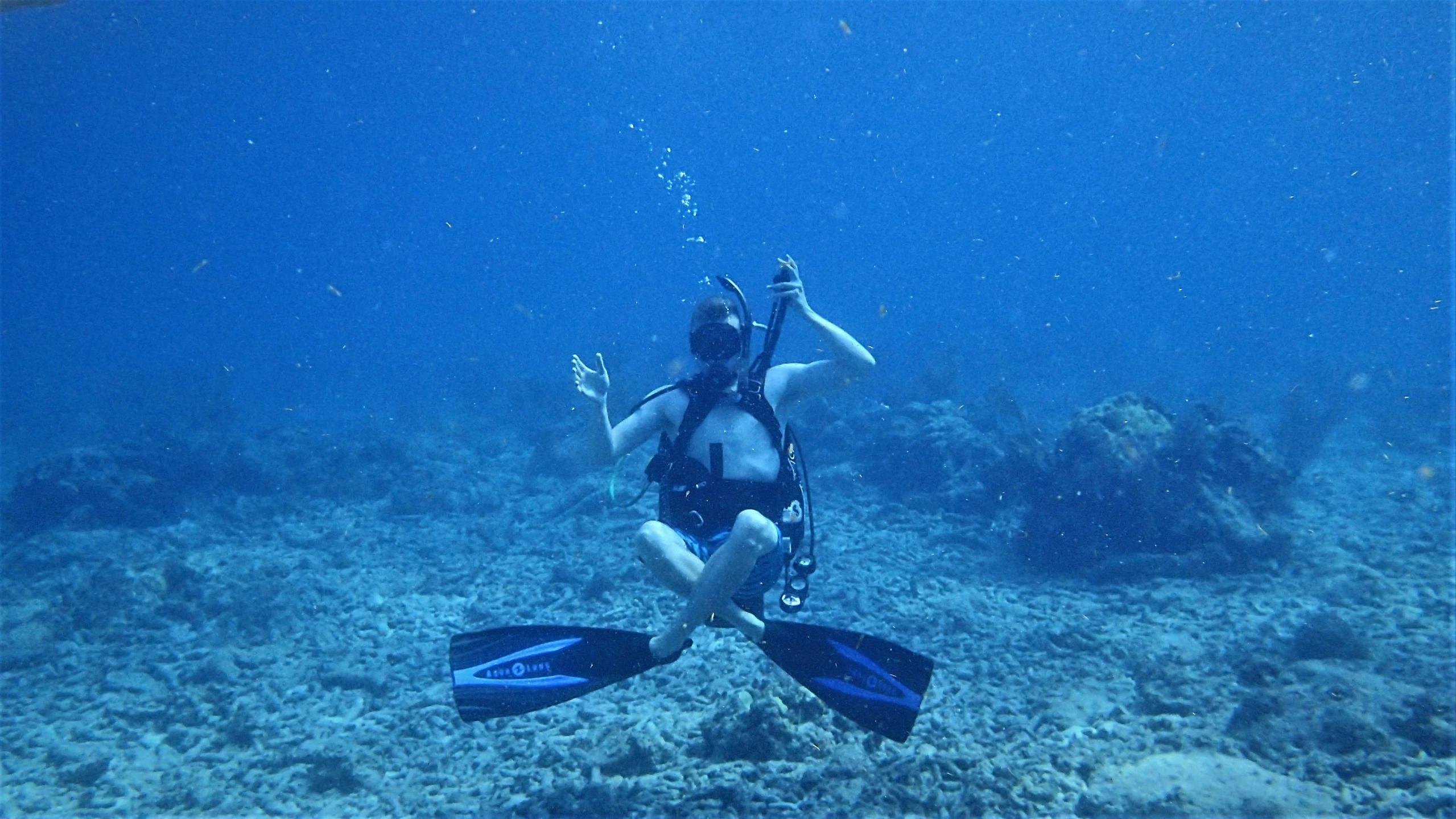 the man is in the water with his hands up