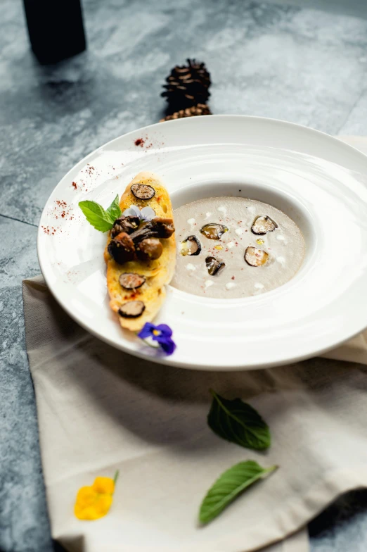 a white bowl filled with liquid and mushrooms