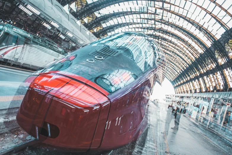 a train is sitting in an indoor terminal