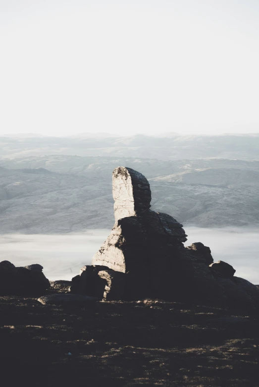 there is a very small stone tower on the hill