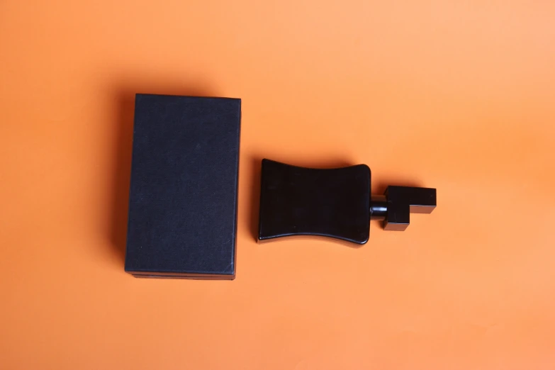 a book, case and tie on an orange background