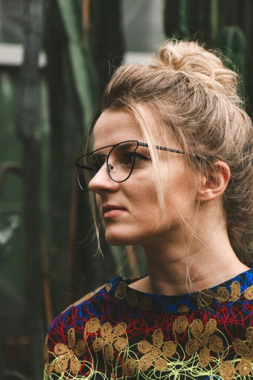 a girl with blonde hair and black glasses