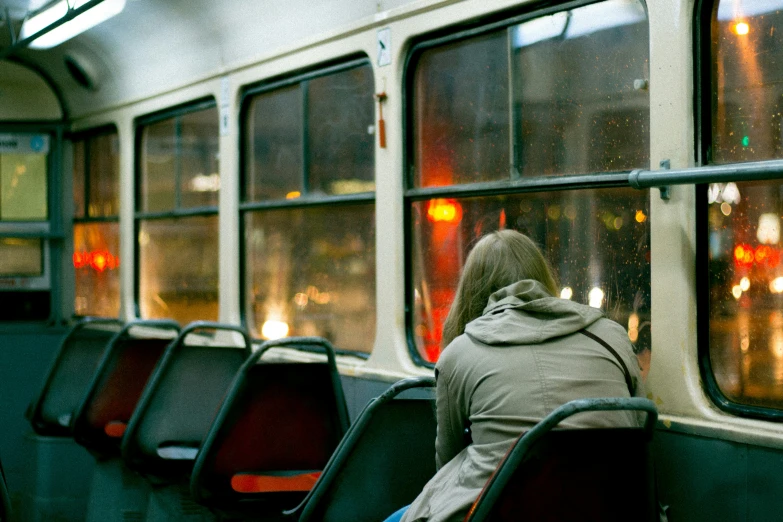 a person is sitting down on a train