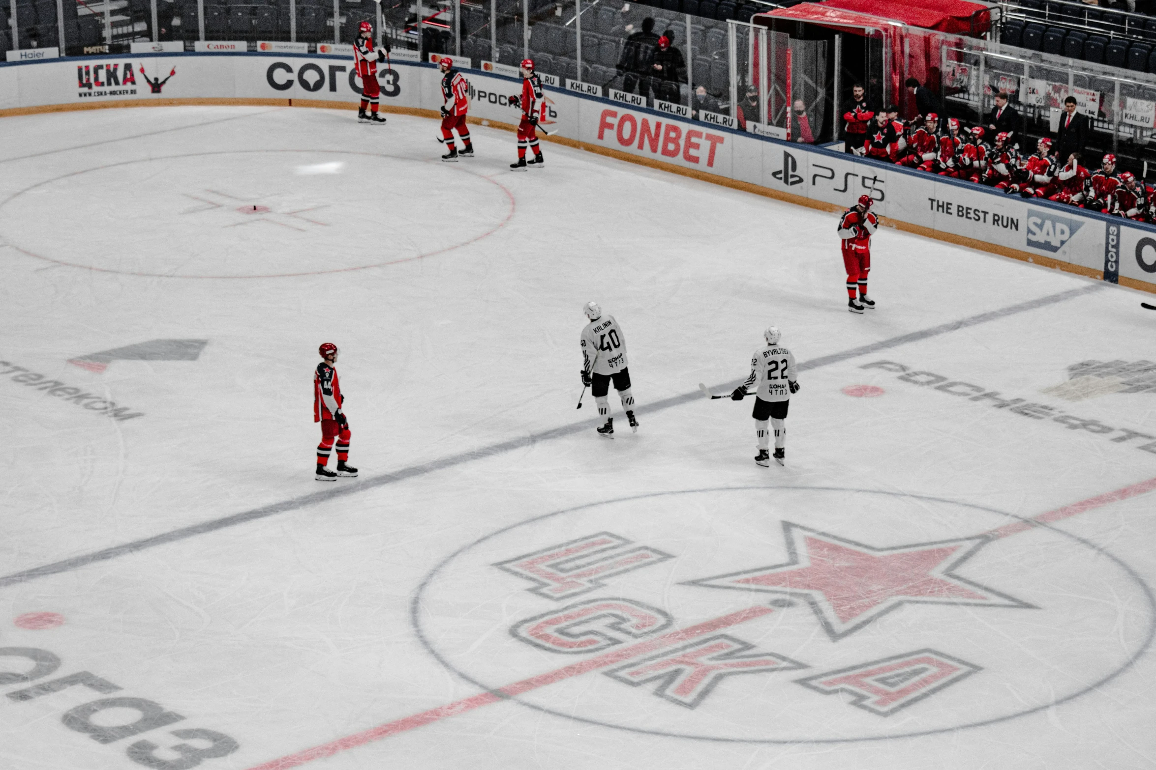 an indoor ice hockey rink is decorated in red and white