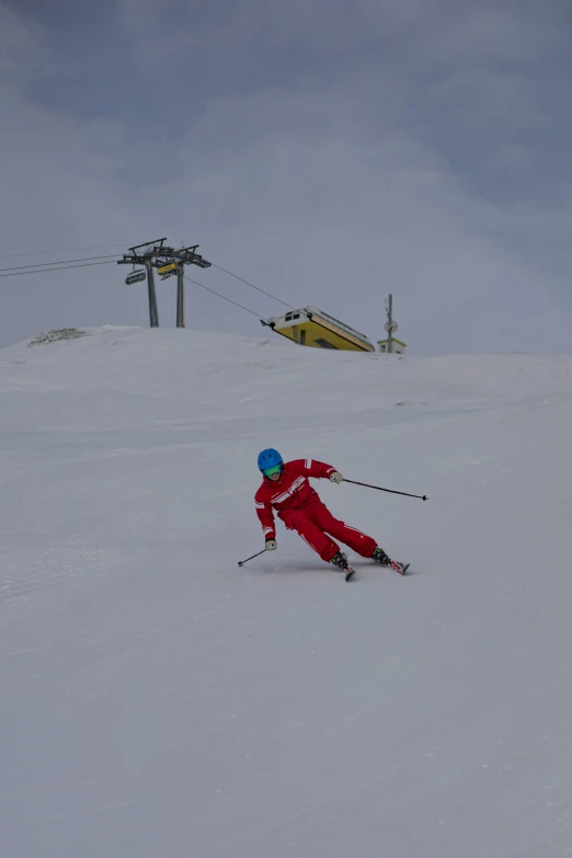 a man in red skis down the side of a mountain