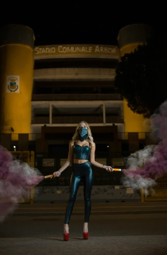 a woman in blue costume posing on the street
