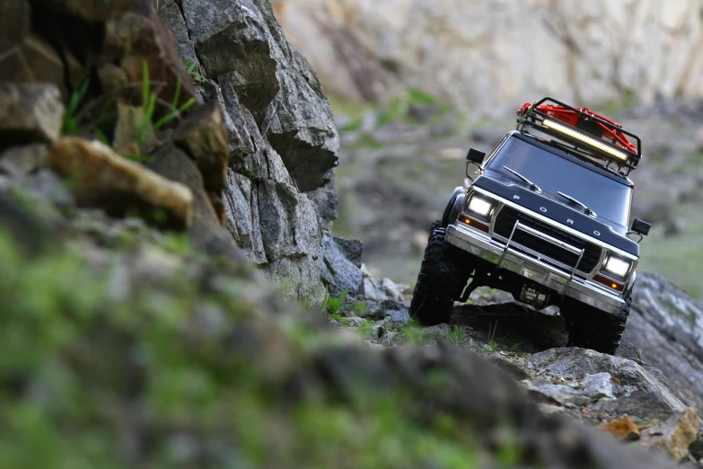 a pick up truck driving on rocks and dirt