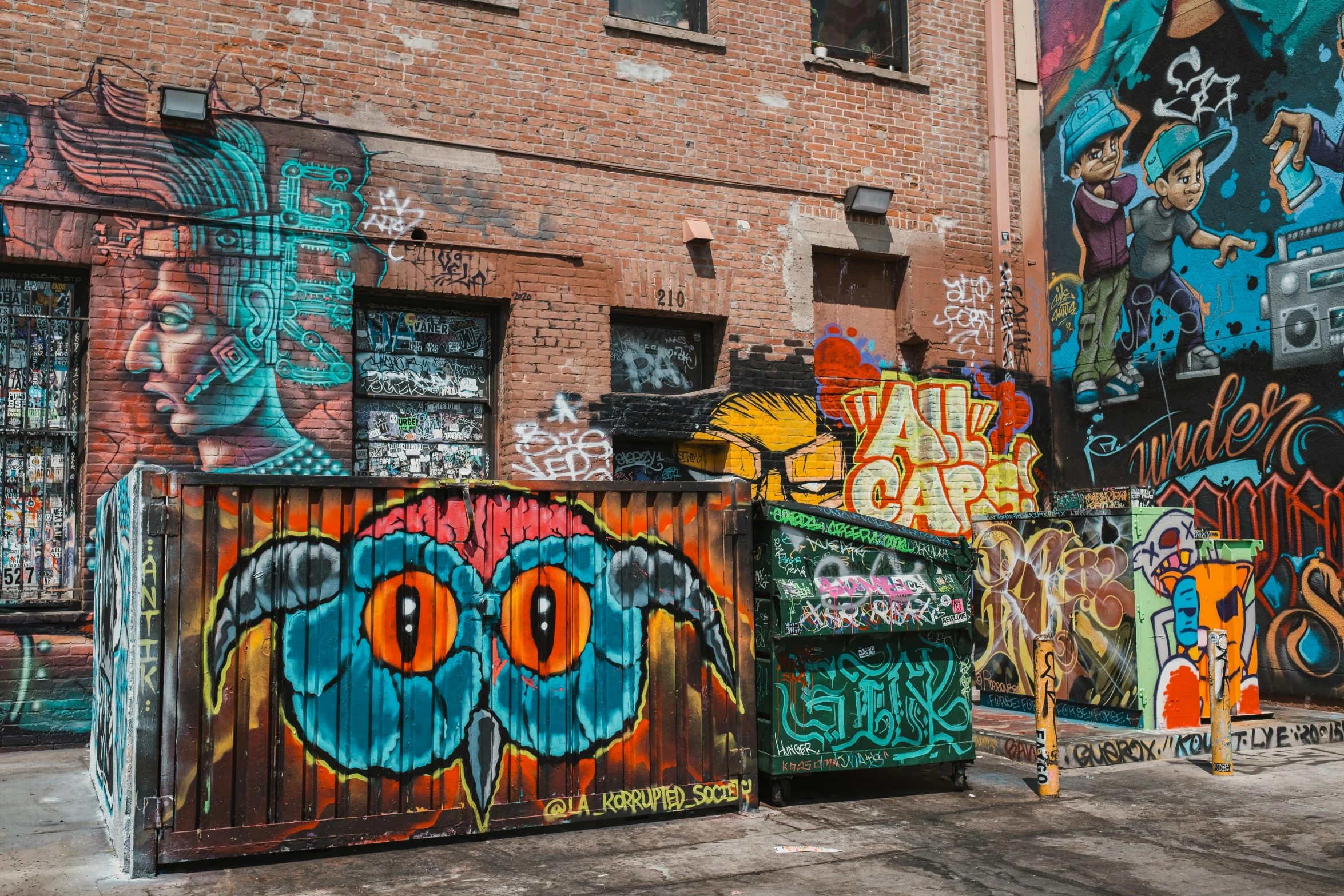 graffiti on the side of a building next to a fire hydrant