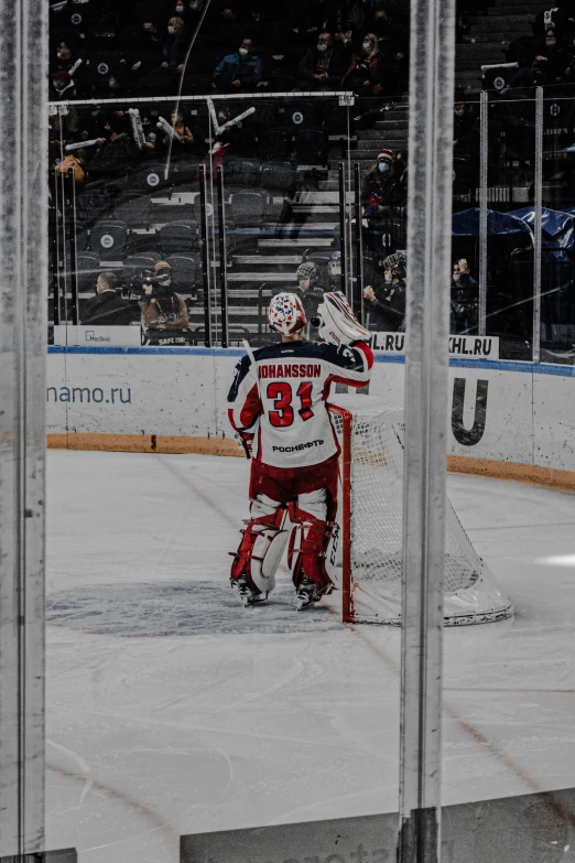 goalie getting ready to play hockey on a rink