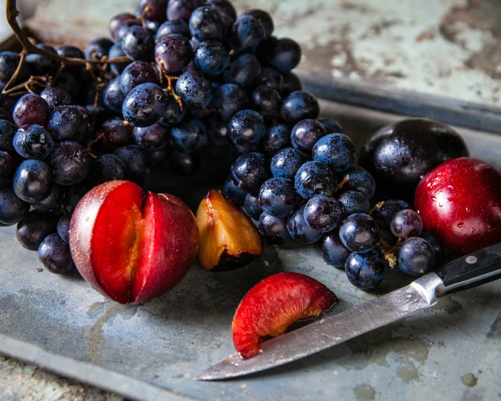 fruit is placed on a  board with a knife