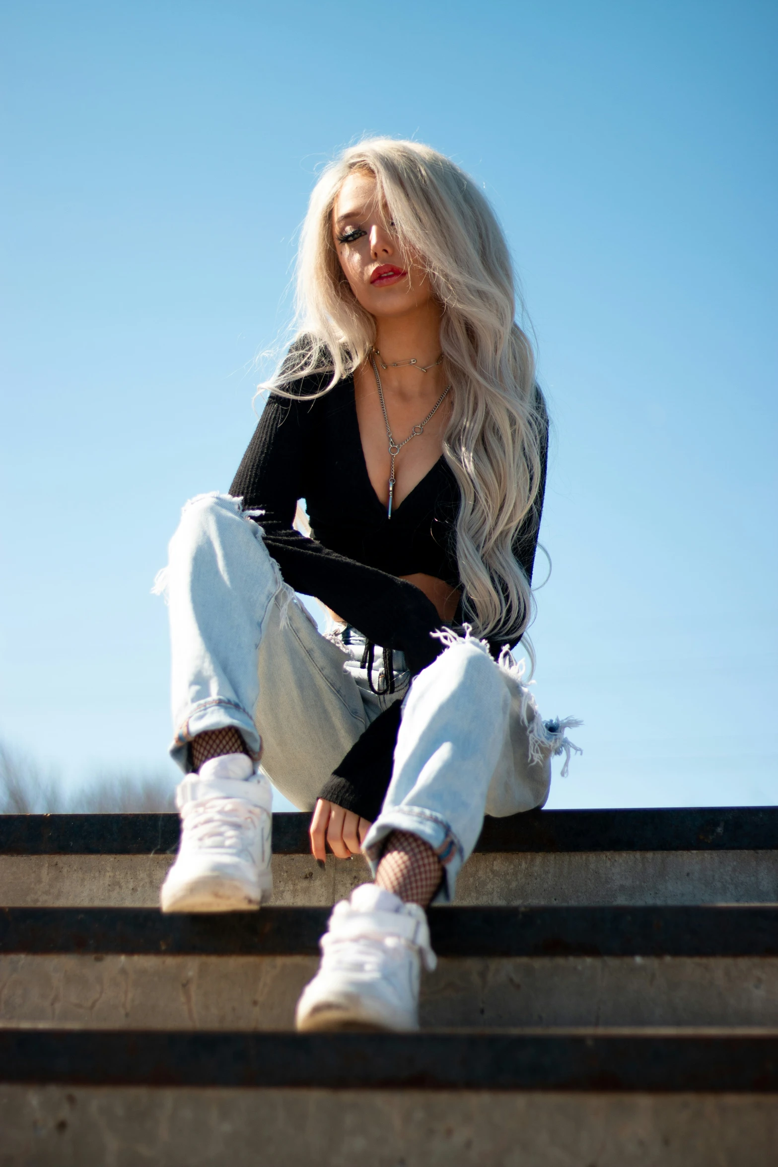 a woman is sitting on top of a set of stairs