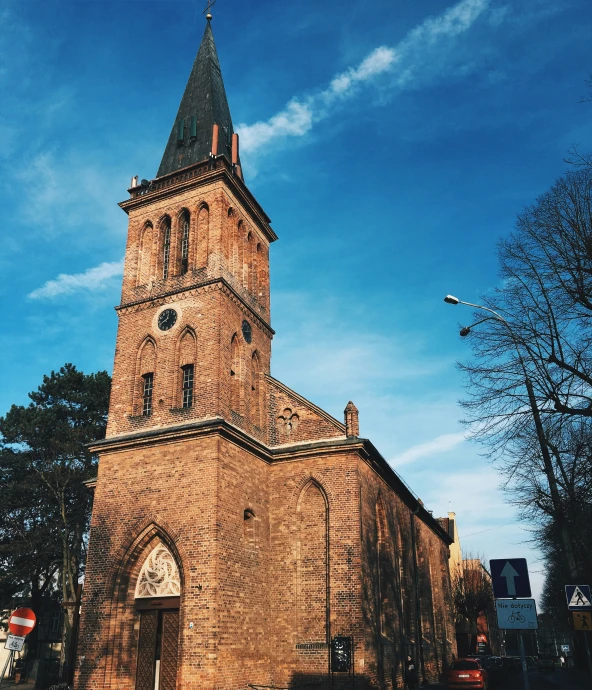 an old church sitting on the side of a street