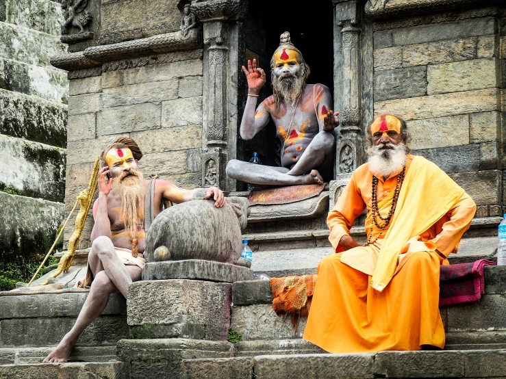 a couple of men that are sitting on some steps