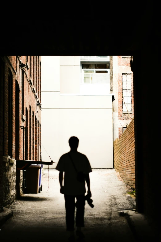 the man is standing in the alley way