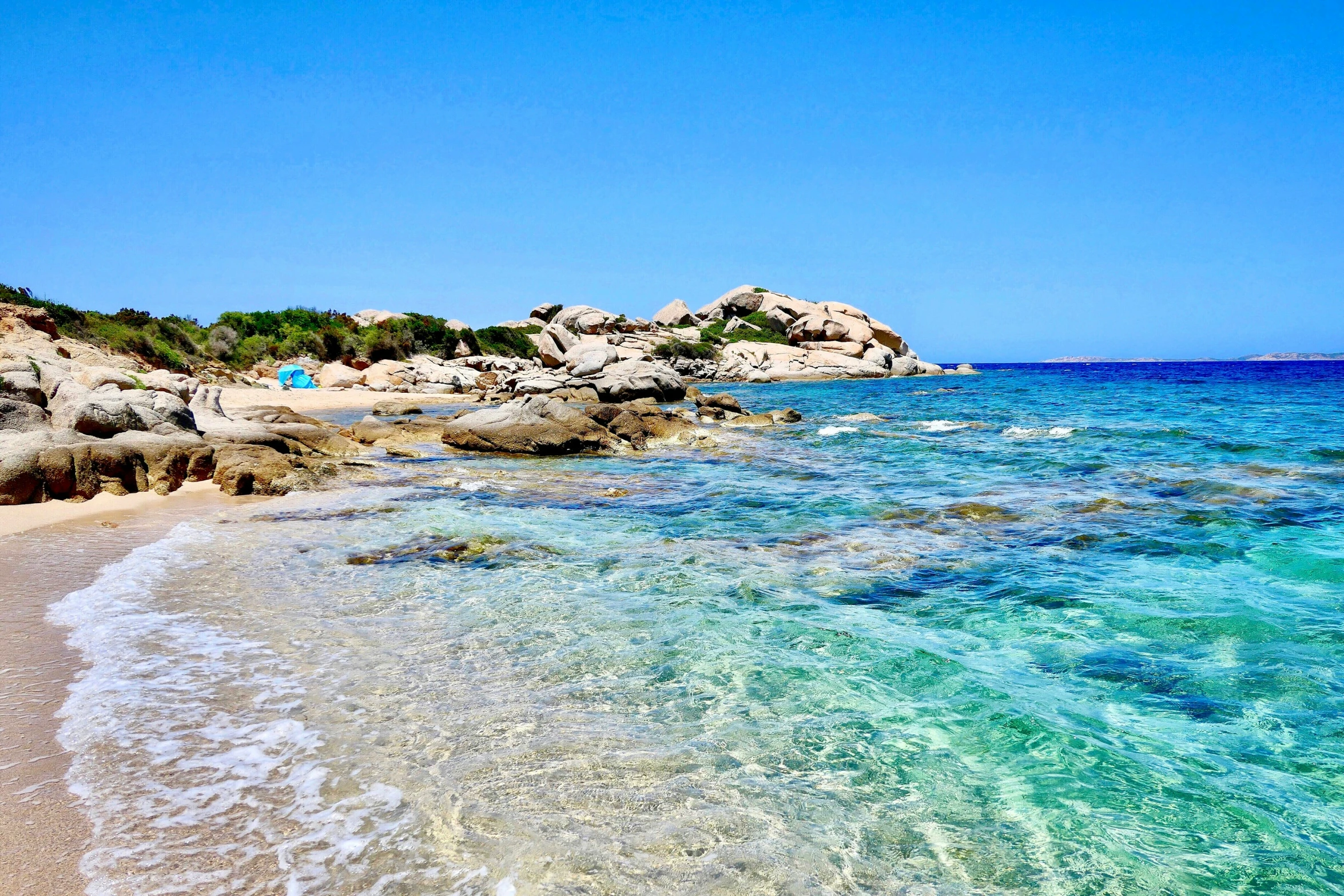 the water of a beach with small houses