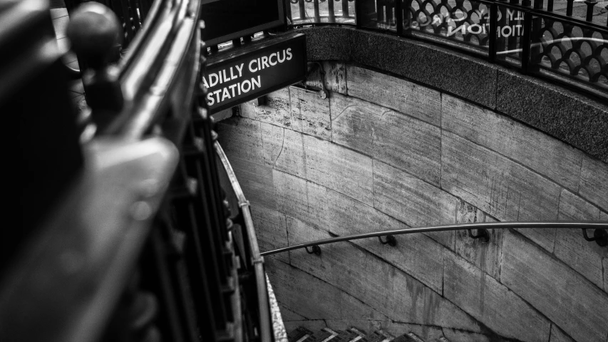 some street signs in a curved stairway area