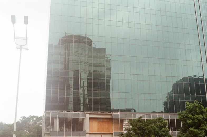 the reflection of a building in the glass window