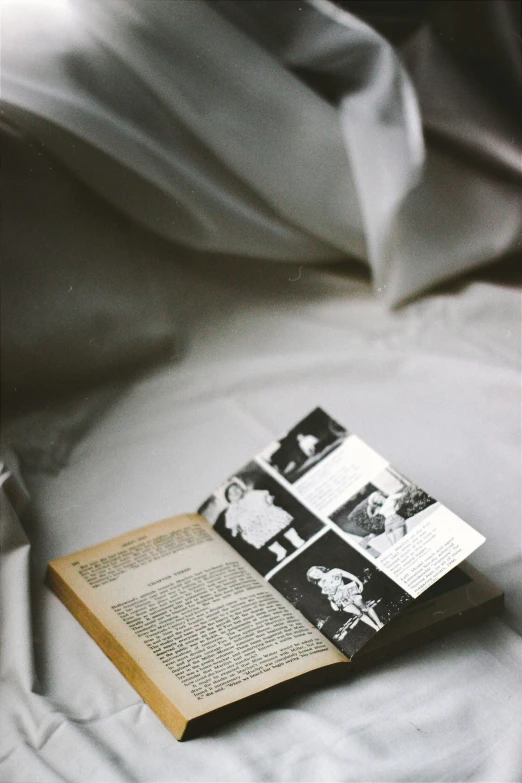 a book on a bed with pillows