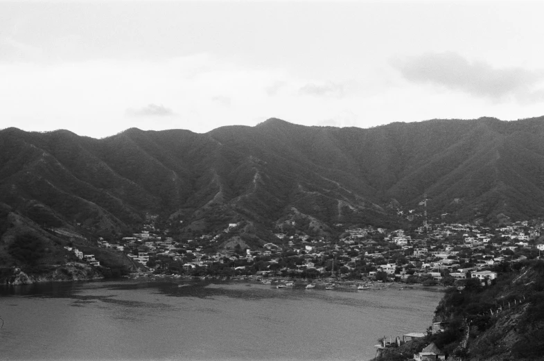 a black and white po of a city near a lake