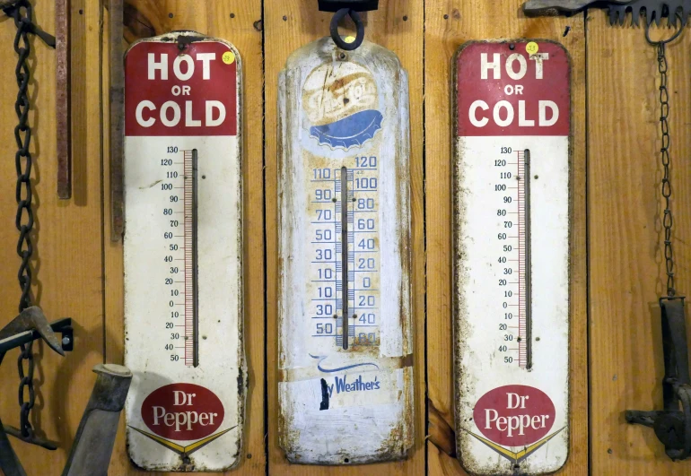 four different heating thermometers mounted to a wall