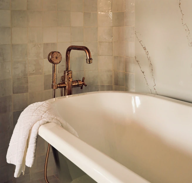 an old bathtub in a bathroom with tile walls