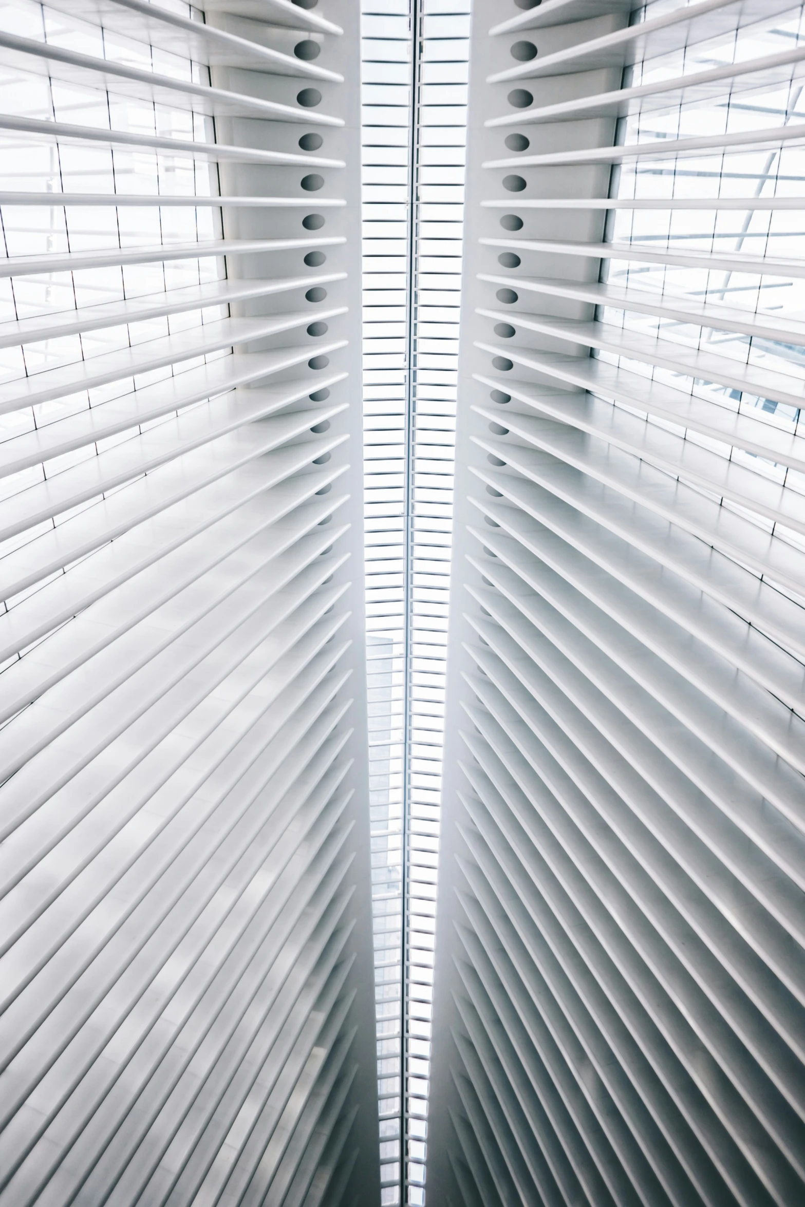 two windows with the blinds closed in front of them