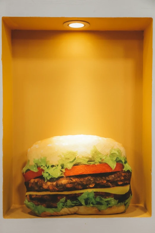 a large stuffed hamburger in a cardboard box