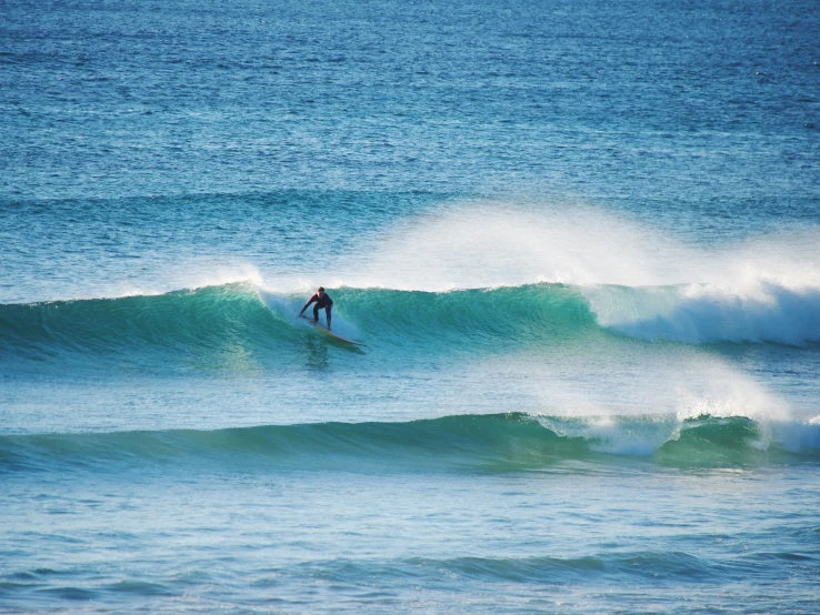 the surfer is riding on a big wave