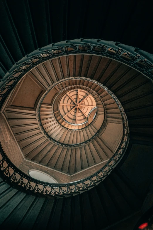 a spiral staircase in a building with lights shining