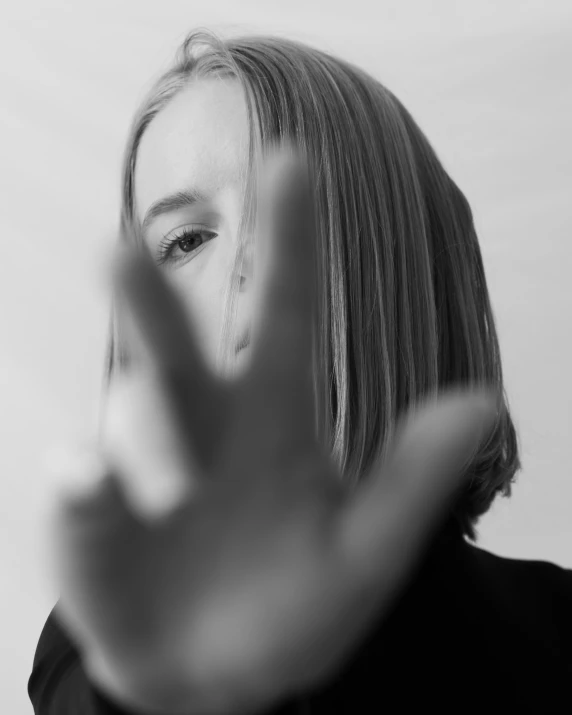 a woman making a hand gesture on her face