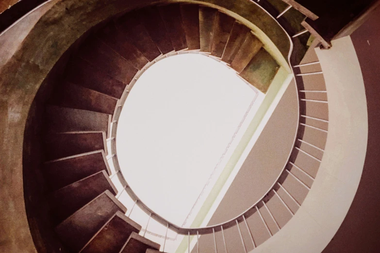 looking down at an old spiral staircase on a cloudy day