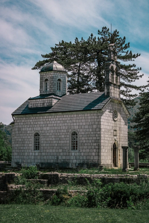 a white building with a clock tower surrounded by trees