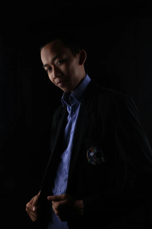 an asian man dressed nicely in blue and black