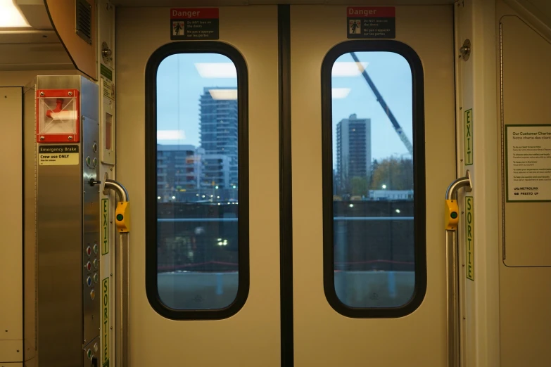 a train door with two double - doors, near a window that reads n