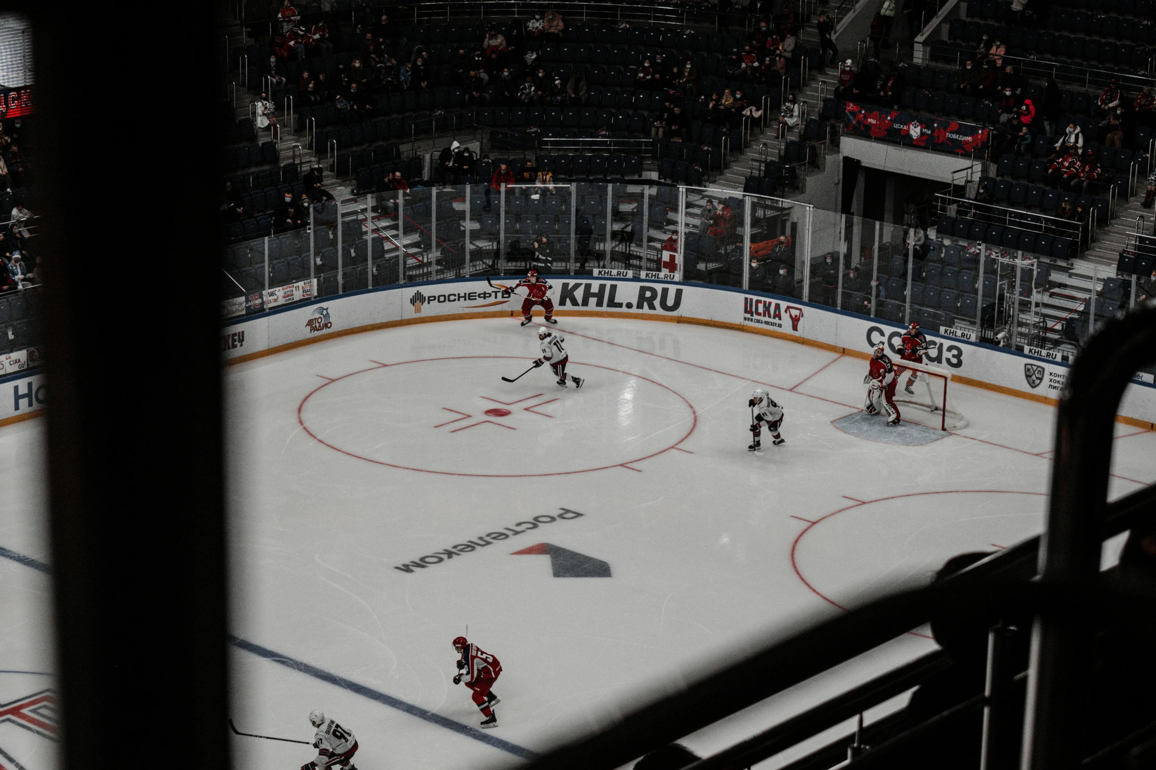 a hockey game in progress with the goalie ready to kick the puck