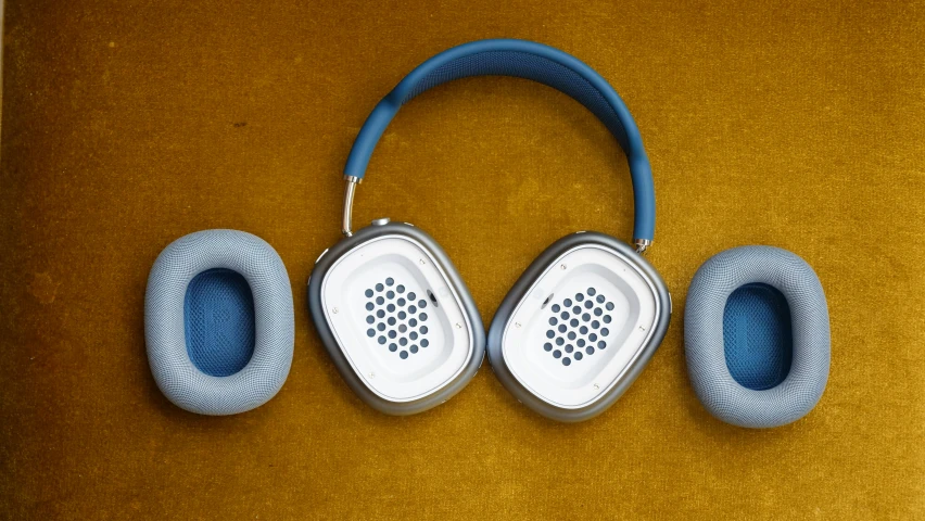 headphones sitting on top of an orange surface