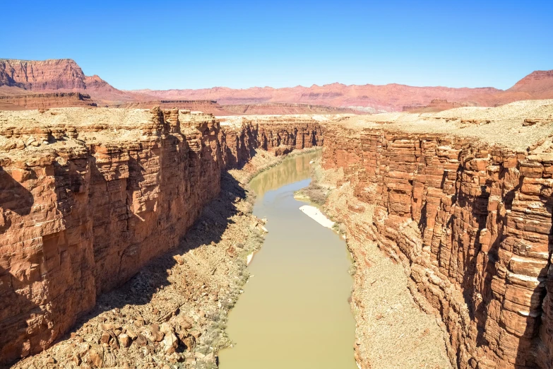 a river running through a canyon surrounded by rocky walls