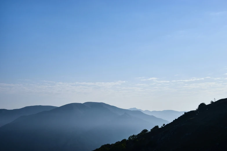 a group of hikers atop a mountain enjoying the sun