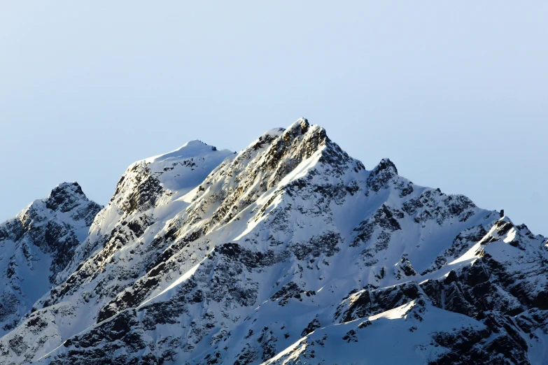 snow capped mountains with a blue sky background