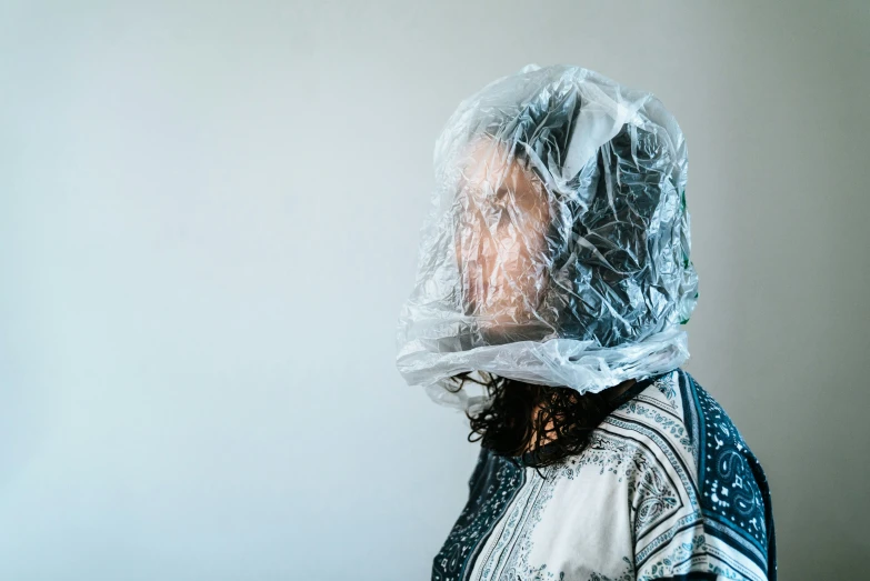 a woman with a plastic bag on her head