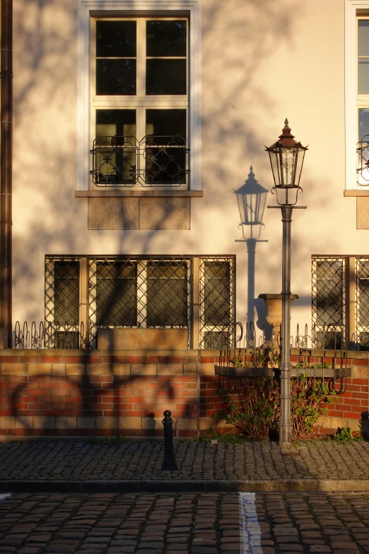 street lamp sitting next to a building with windows