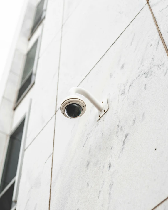 a security camera outside of a building on the side