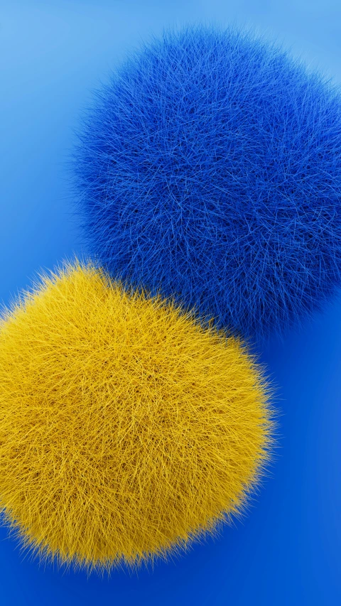 two very colorful balls sitting in a blue surface