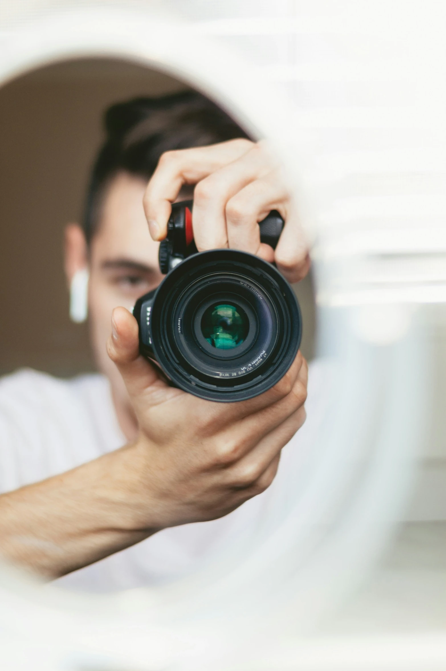 a man holds his camera up to take a po